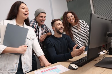 Photo of Team of employees working together in office. Startup project