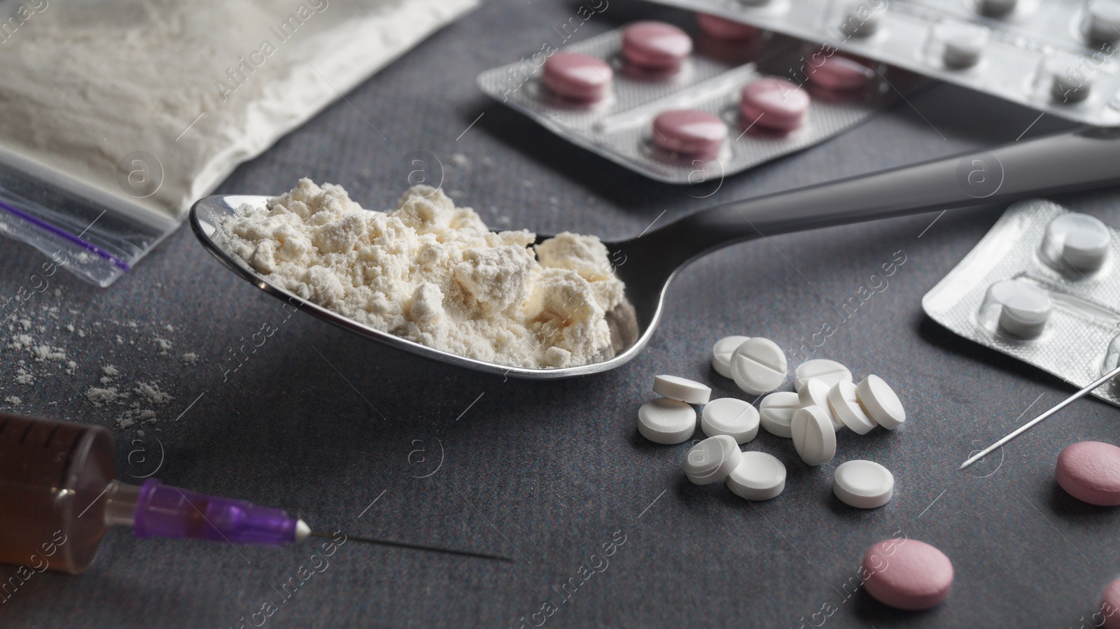 Photo of Different hard drugs on light grey table, closeup