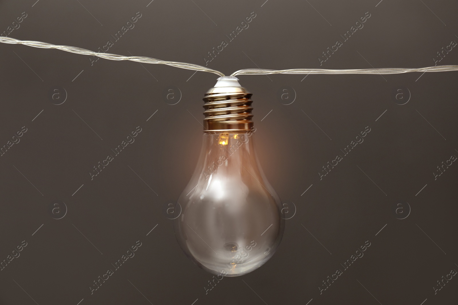 Photo of Lamp with light bulb on grey background