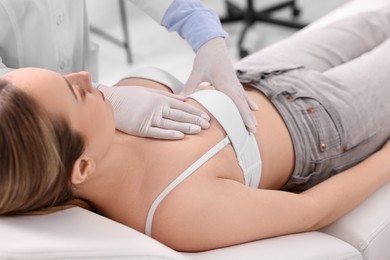 Mammologist checking young woman's breast in hospital