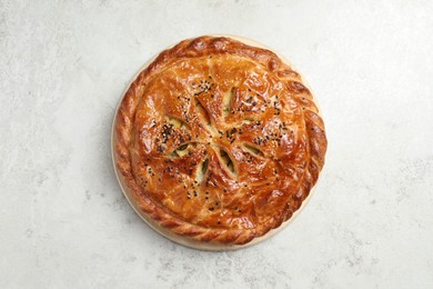 Tasty homemade pie with filling on light table, top view