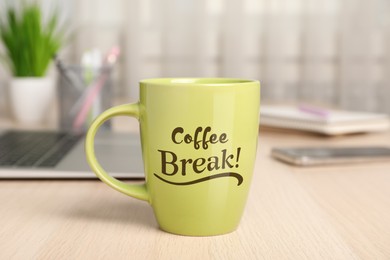 Image of Mug with inscription Coffee Break on wooden table in office