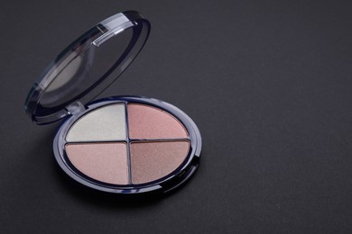Photo of Contouring palette on black background, space for text. Professional cosmetic product