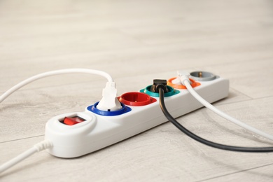 Photo of Extension cord on floor. Electrician's professional equipment