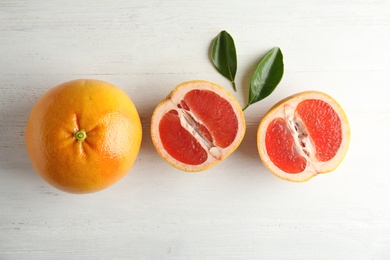 Photo of Fresh tasty grapefruits on wooden background, top view