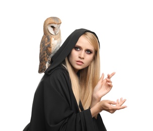 Photo of Witch in black mantle with owl isolated on white. Scary fantasy character