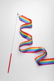 Photo of Rainbow gymnastics ribbon on white background, top view. LGBT pride