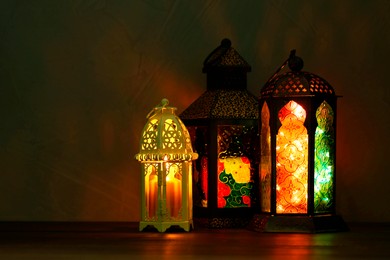 Photo of Decorative Arabic lanterns on table against dark background