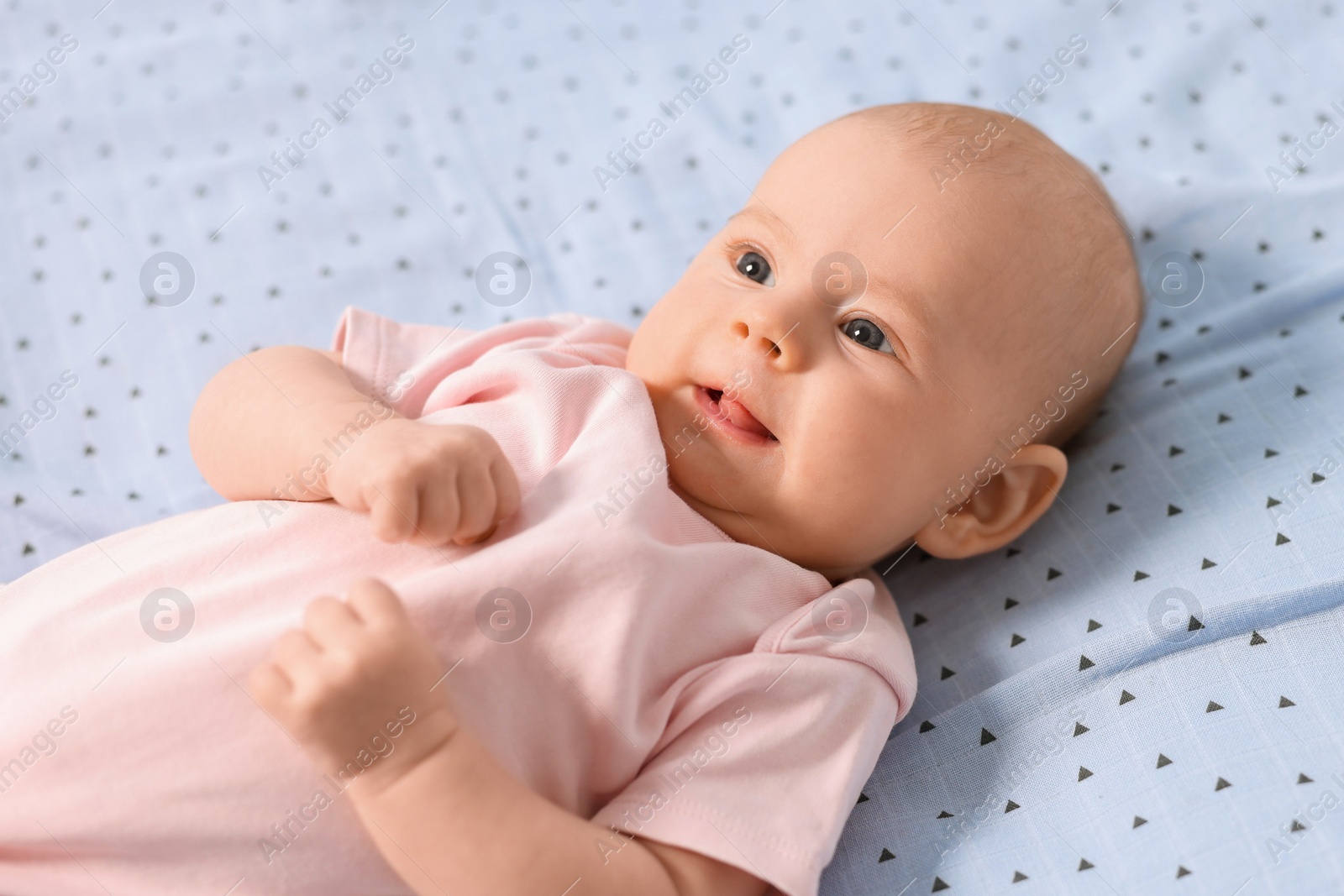 Photo of Cute little baby lying in crib at home