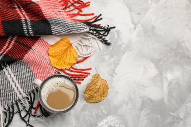 Photo of Flat lay composition with coffee and warm plaid on grey table, space for text