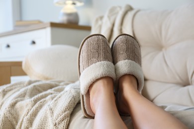 Photo of Woman wearing soft comfortable slippers at home, closeup