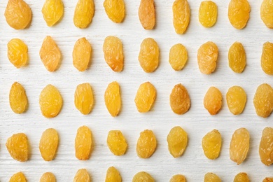 Photo of Flat lay composition with raisins on white wooden background. Dried fruit as healthy snack