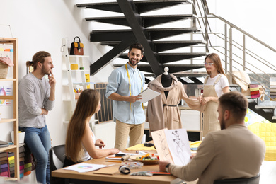 Photo of Fashion designers creating new clothes in studio