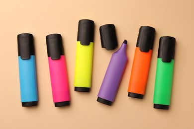Photo of Bright color markers on beige background, flat lay