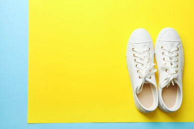 Photo of Stylish sneakers on color background, top view with space for text