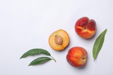 Photo of Flat lay composition with sweet juicy peaches on light background. Space for text
