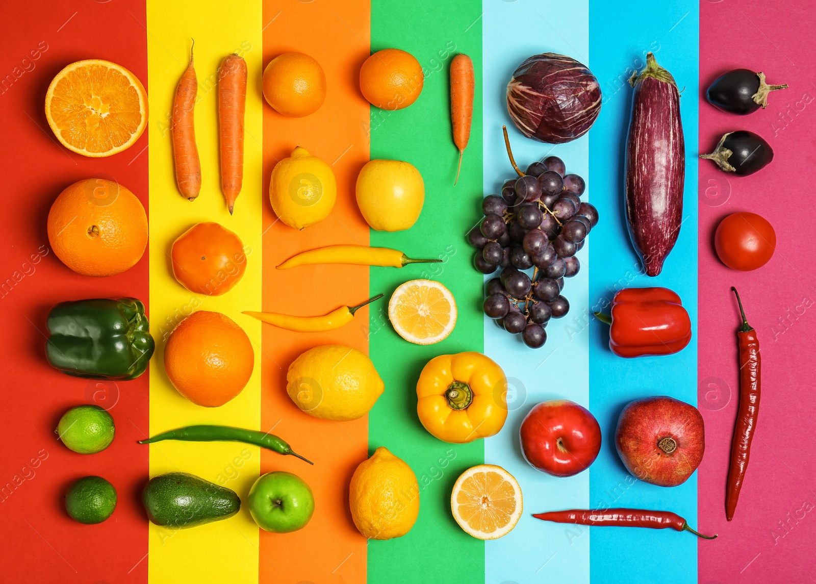 Rainbow composition with fresh vegetables and fruits on color background, flat lay Photo of Rainbow composition with fresh vegetables and fruits on color background, flat lay