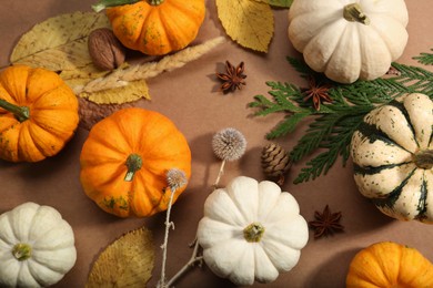 Photo of Thanksgiving day. Flat lay composition with pumpkins on light brown background