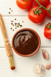 Photo of Flat lay composition with tasty barbeque sauce in bowl on white wooden table