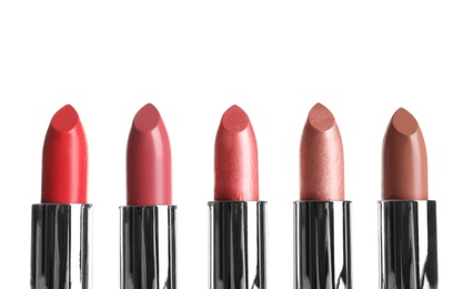 Photo of Different lipsticks on white background. Cosmetic product