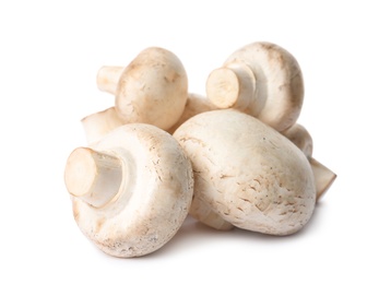 Photo of Fresh champignon mushrooms isolated on white. Healthy food