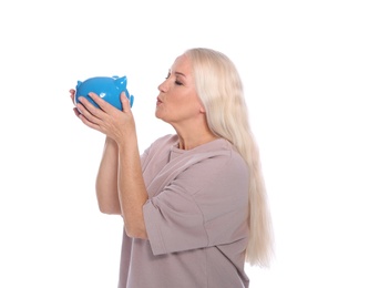 Photo of Mature woman with piggy bank on white background