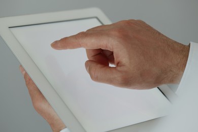 Photo of Closeup view of man using new tablet indoors
