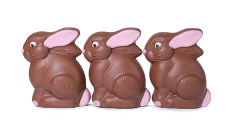 Photo of Many chocolate bunnies isolated on white. Easter celebration