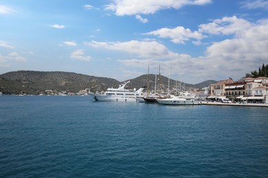 Beautiful view of different boats in sea near shore on sunny day