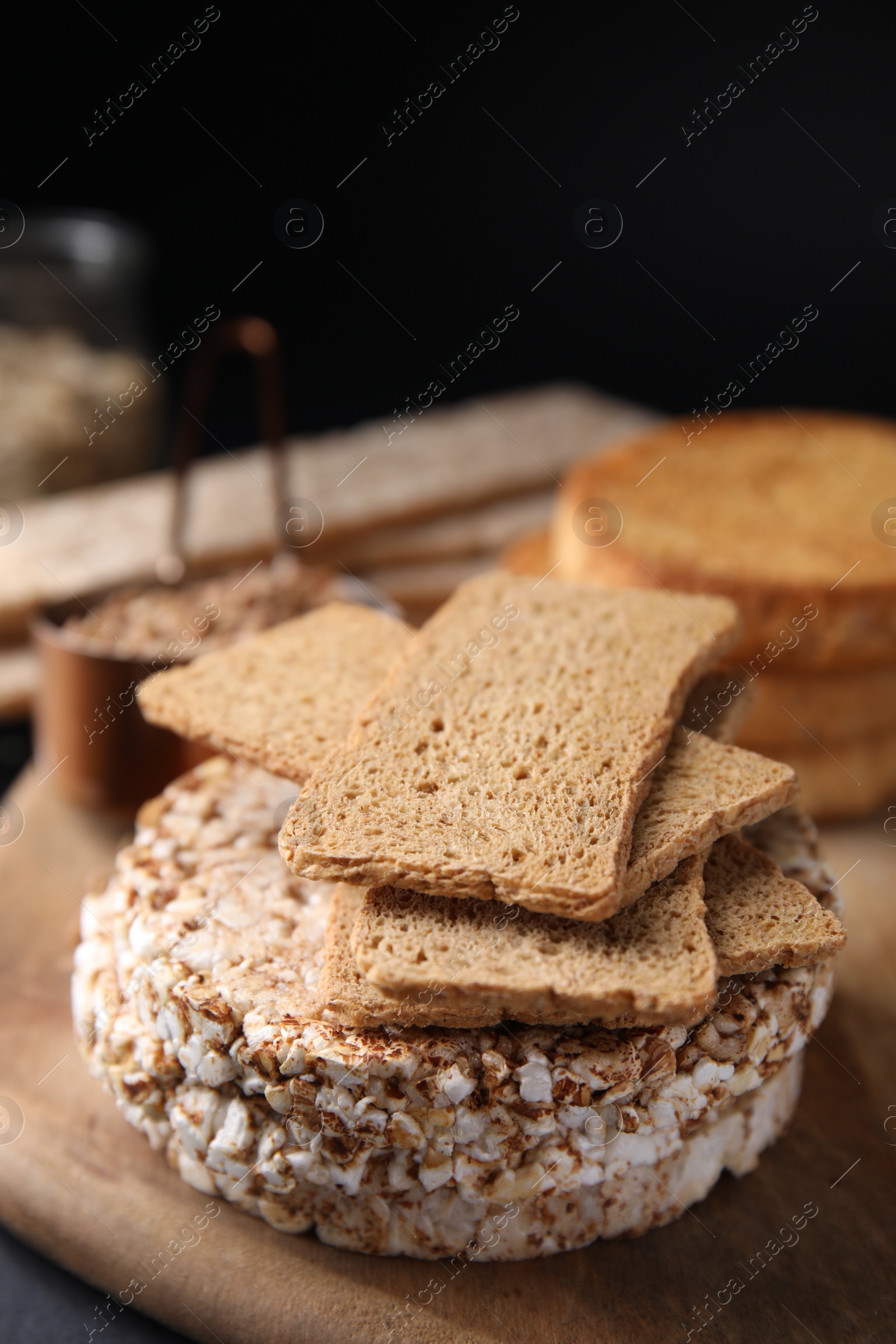 Photo of Rye crispbreads, rice cakes and rusks on table, closeup
