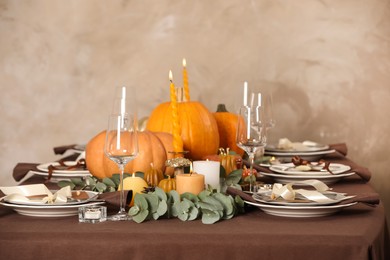 Photo of Beautiful autumn place setting and decor on table in room