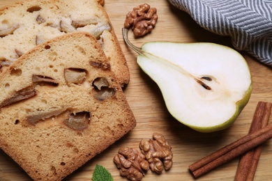 Photo of Flat lay composition with bread and pear on black table. Homemade cake