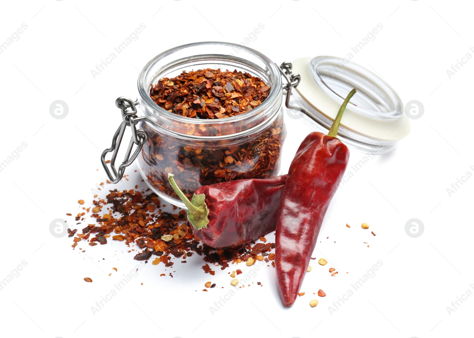 Photo of Jar with crushed chili pepper and pods on white background