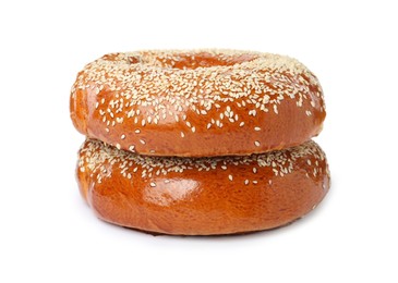 Photo of Delicious fresh bagels with sesame seeds on white background