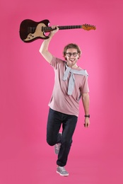 Photo of Young man with electric guitar on color background