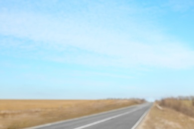 Photo of Blurred view of blue sky and asphalt road