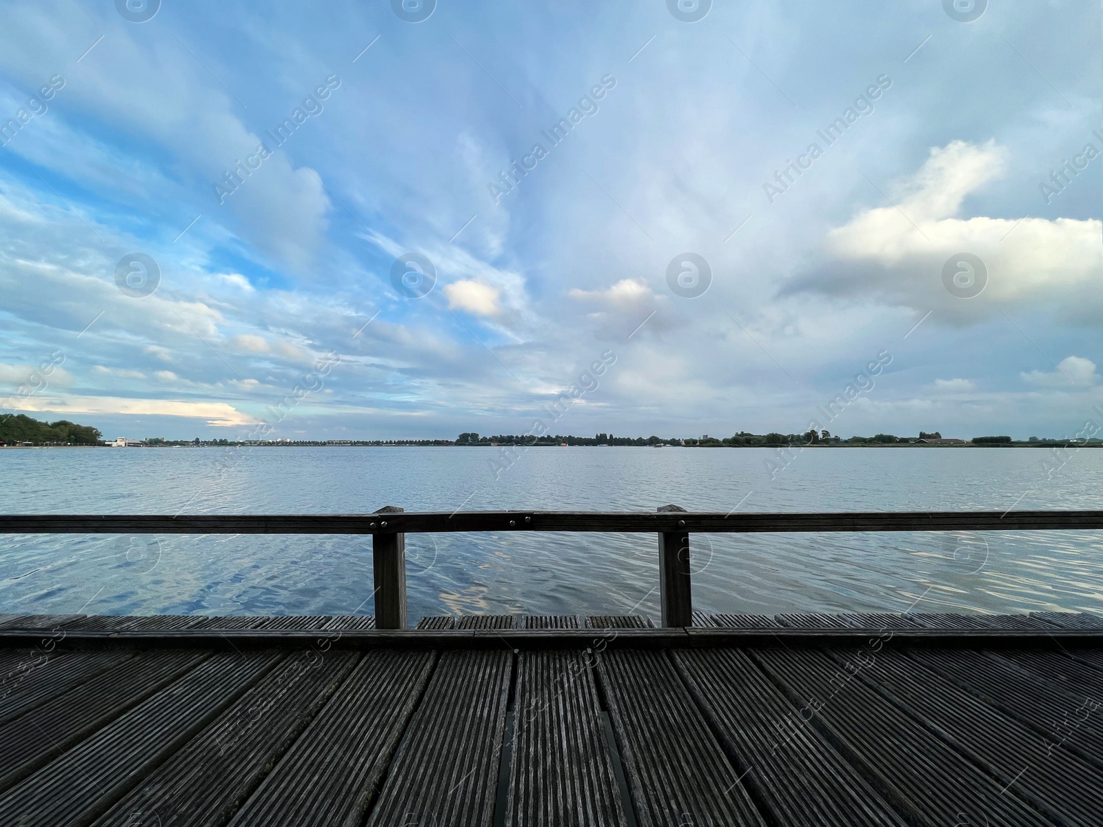 Photo of Picturesque view of river wooden pier and cloudy sky