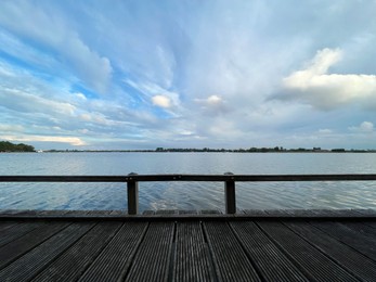 Photo of Picturesque view of river wooden pier and cloudy sky