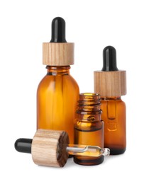 Bottles of essential oil and dropper on white background