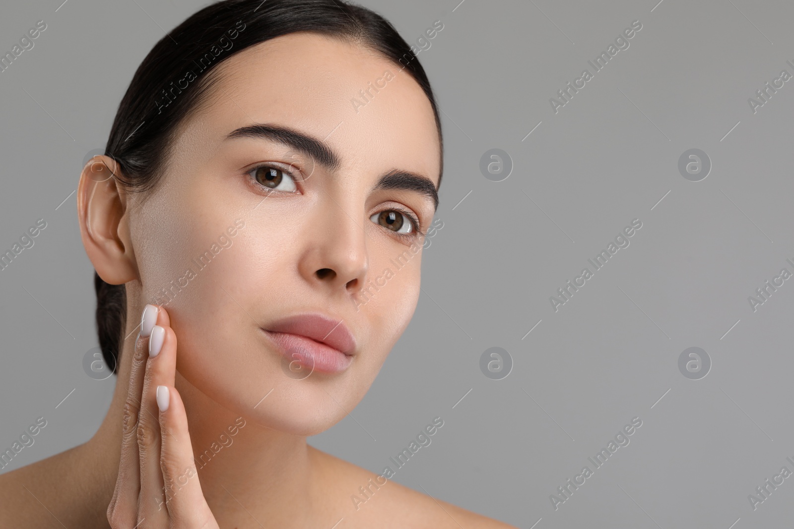 Photo of Young woman with dry skin on gray background, closeup. Space for text