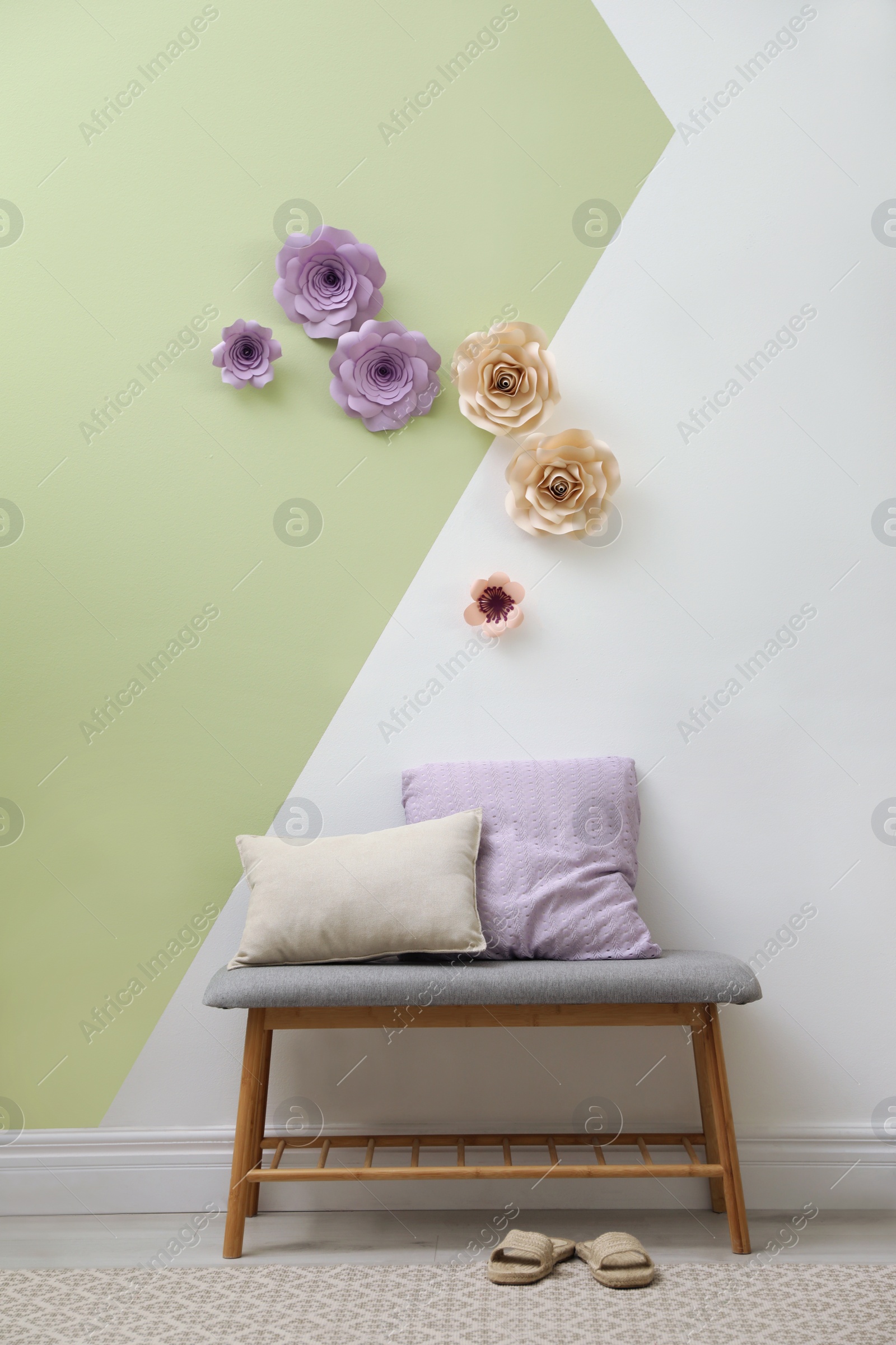 Photo of Stylish room interior with indoor bench and floral decor on wall