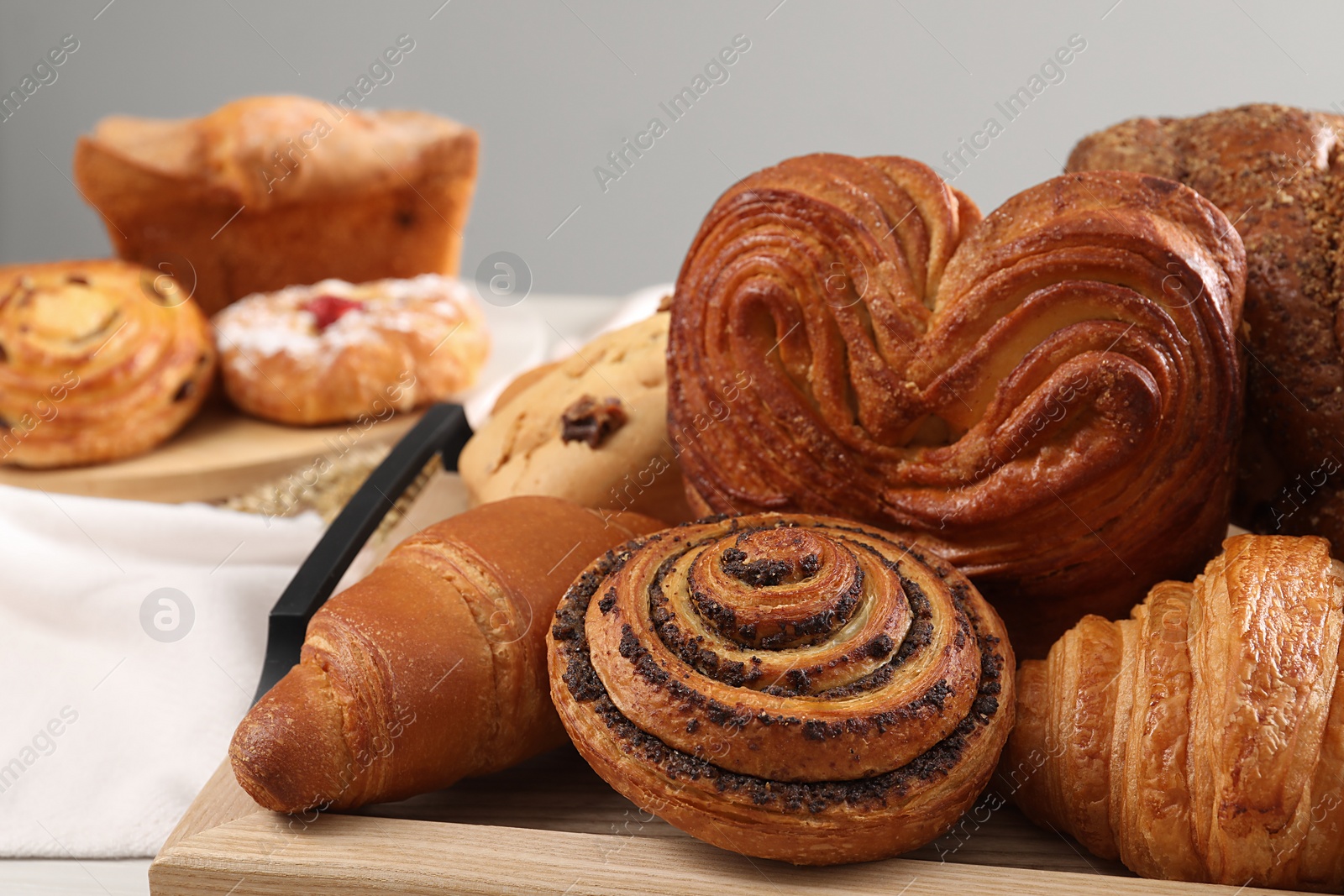 Photo of Different tasty freshly baked pastries on table, closeup