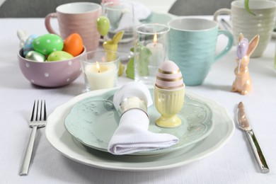 Photo of Easter celebration. Festive table setting with painted eggs.