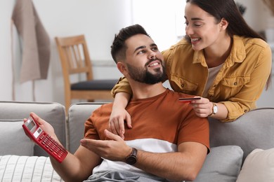 Photo of Young couple discussing family budget at home