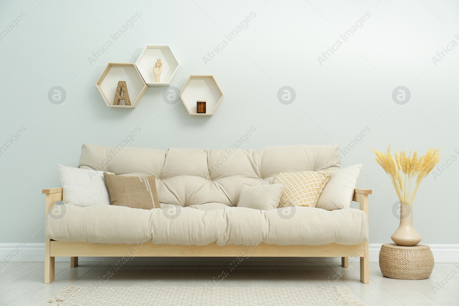 Photo of Stylish beige sofa in living room interior