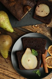 Photo of Flat lay composition with tasty pear bread on wooden table. Homemade cake