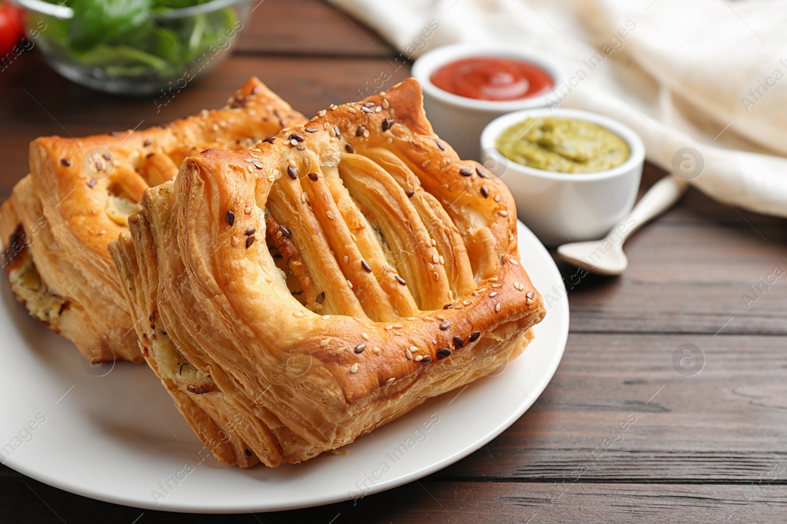 Photo of Fresh delicious puff pastry served on wooden table