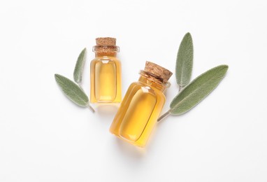 Photo of Bottle of essential sage oil and leaves on white background, top view