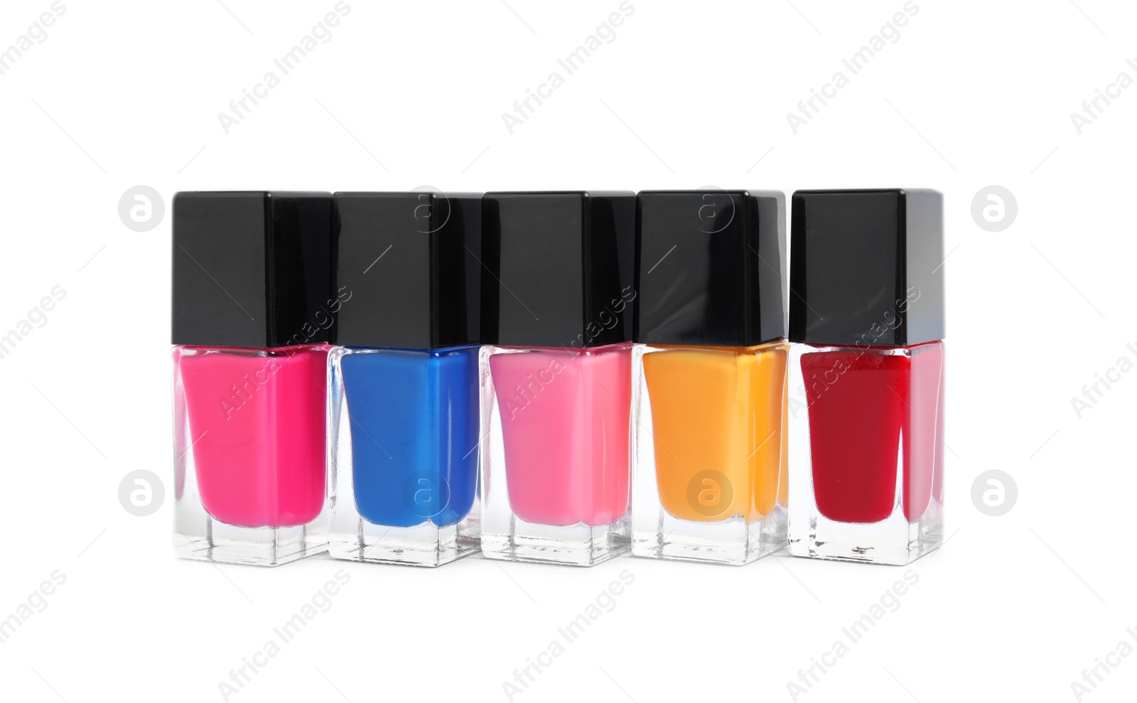 Photo of Bottles of nail polish on white background