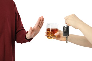 Photo of Man refusing alcoholic drink while woman suggesting him car keys and glass of whiskey, closeup. Don't drink and drive concept